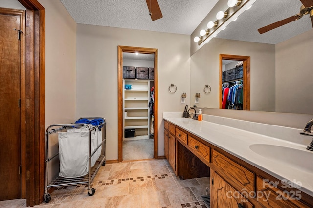 266 Asheland Dr, Ellenboro, NC 28040 - full bathroom featuring a sink, double vanity, a textured ceiling, and a ceiling fan