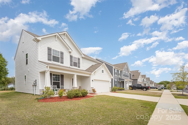 view of front of house with concrete driveway, covered porch, a front yard, a garage, and a residential view