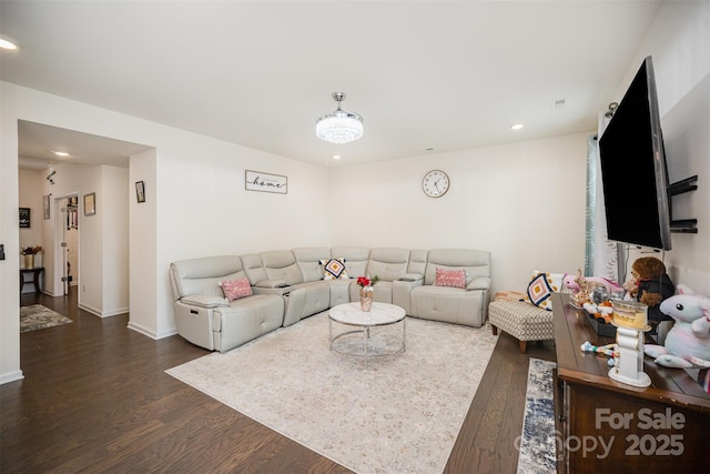 living room featuring recessed lighting, baseboards, and dark wood-style flooring