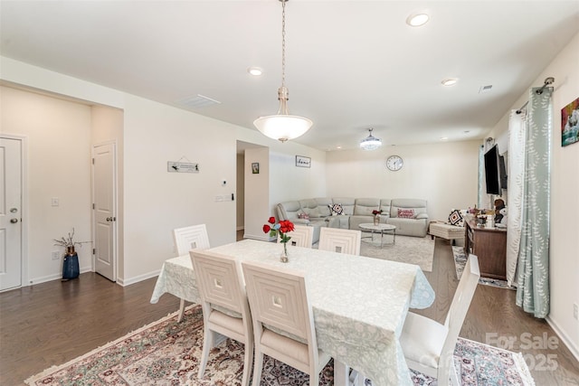 dining space with baseboards, recessed lighting, and dark wood-style flooring