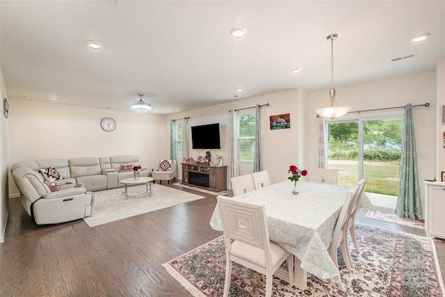 dining space with wood finished floors, visible vents, recessed lighting, and a fireplace