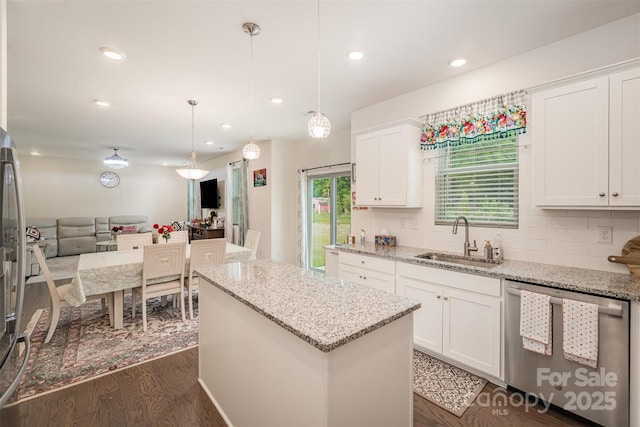 kitchen featuring a center island, a sink, dark wood-style flooring, open floor plan, and dishwasher