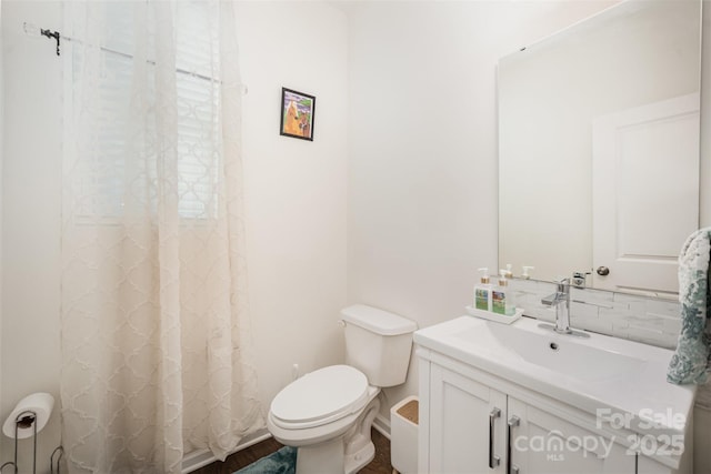 bathroom featuring curtained shower, backsplash, wood finished floors, toilet, and vanity