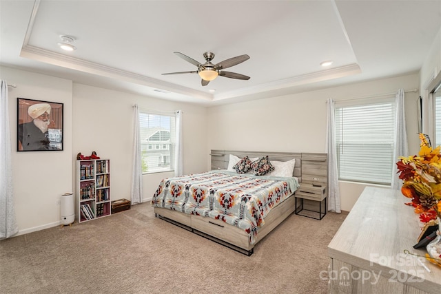 bedroom featuring light colored carpet, crown molding, and a raised ceiling