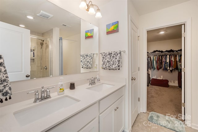full bath with visible vents, a stall shower, and a sink