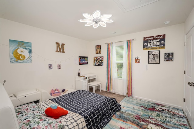 bedroom featuring attic access, carpet flooring, and baseboards