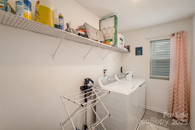 laundry area with washer and dryer, baseboards, tile patterned floors, and laundry area
