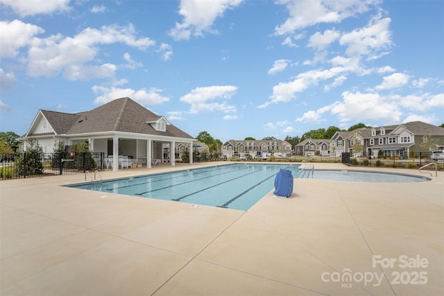 pool featuring fence, a residential view, and a patio