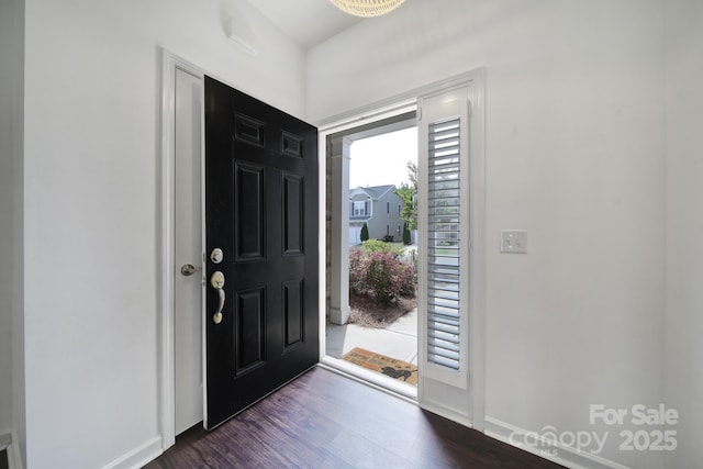 foyer with baseboards and dark wood finished floors