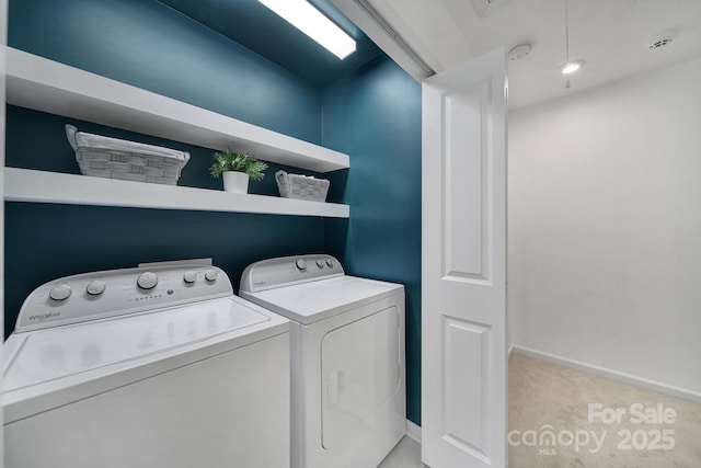laundry room featuring washing machine and clothes dryer, light colored carpet, laundry area, and baseboards