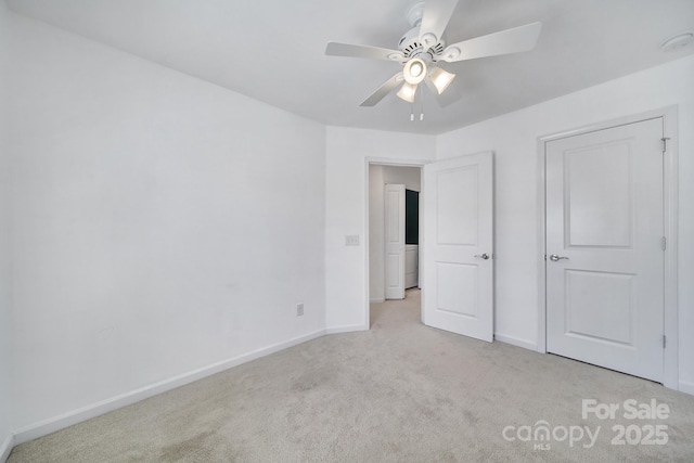 unfurnished bedroom featuring carpet flooring, baseboards, and a ceiling fan