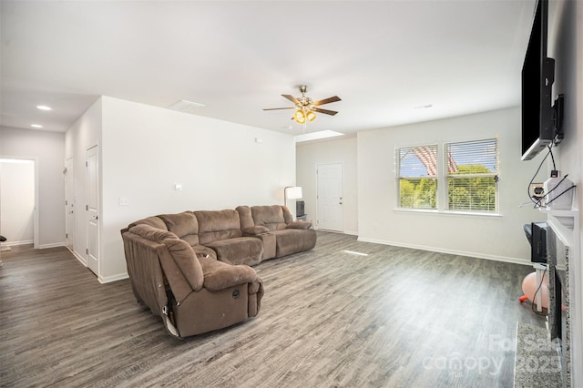 living room with baseboards, a ceiling fan, and wood finished floors