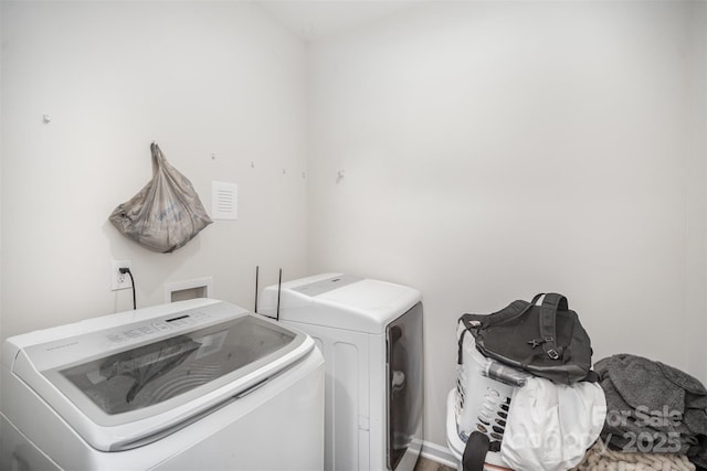 clothes washing area with washer and clothes dryer and laundry area