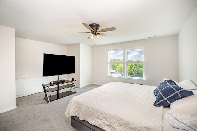 carpeted bedroom featuring baseboards, a ceiling fan, and visible vents