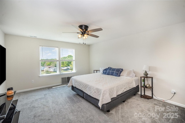 carpeted bedroom with visible vents, baseboards, and ceiling fan