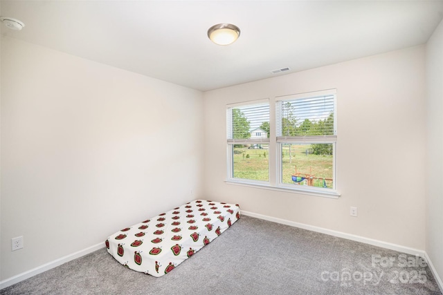 carpeted bedroom with baseboards and visible vents