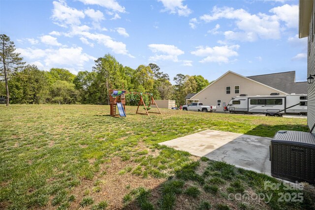 view of yard with a patio and a playground