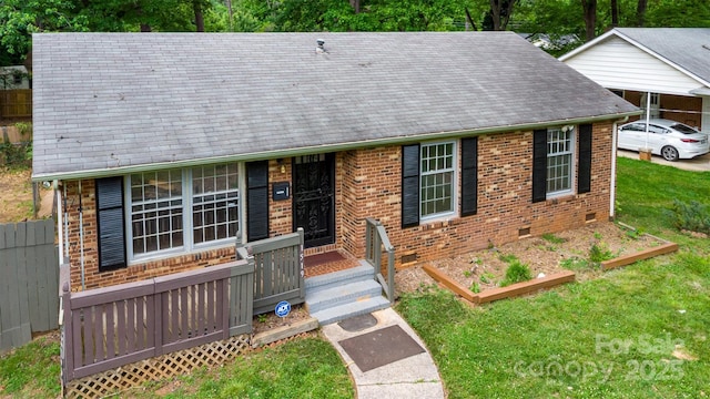 view of front of house featuring brick siding, a shingled roof, and crawl space
