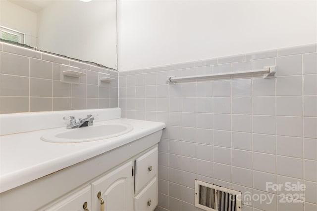 bathroom with tile walls and vanity
