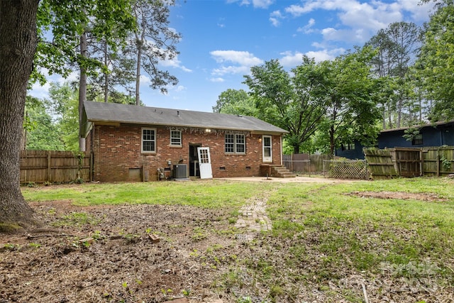 rear view of property featuring brick siding, central AC, and entry steps