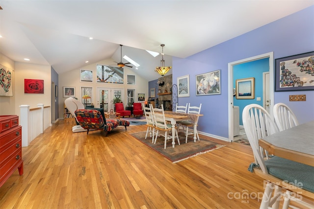 27 Hunting Lodge Dr, Black Mountain, NC 28711 - dining space with a stone fireplace, a ceiling fan, light wood-style flooring, and lofted ceiling