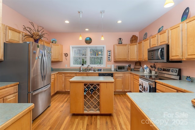 27 Hunting Lodge Dr, Black Mountain, NC 28711 - kitchen featuring light countertops, light wood finished floors, appliances with stainless steel finishes, and light brown cabinets