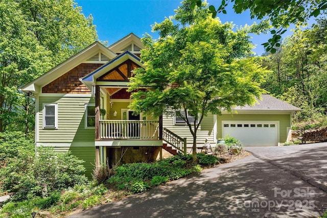 27 Hunting Lodge Dr, Black Mountain, NC 28711 - craftsman-style home with an attached garage, stairs, driveway, and covered porch