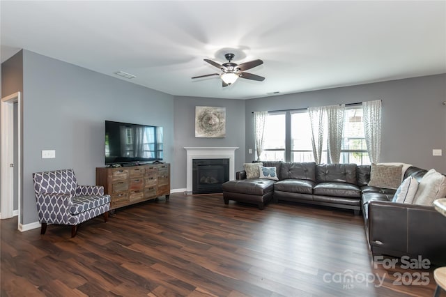4924 Riverdale Dr, Charlotte, NC 28273 - living room featuring a glass covered fireplace, a ceiling fan, visible vents, and dark wood finished floors