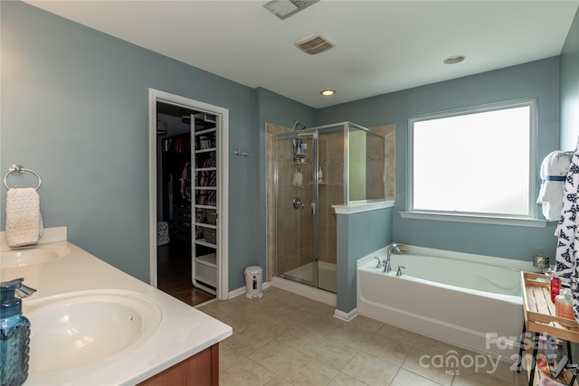 4924 Riverdale Dr, Charlotte, NC 28273 - bathroom featuring a spacious closet, visible vents, a sink, a garden tub, and a stall shower