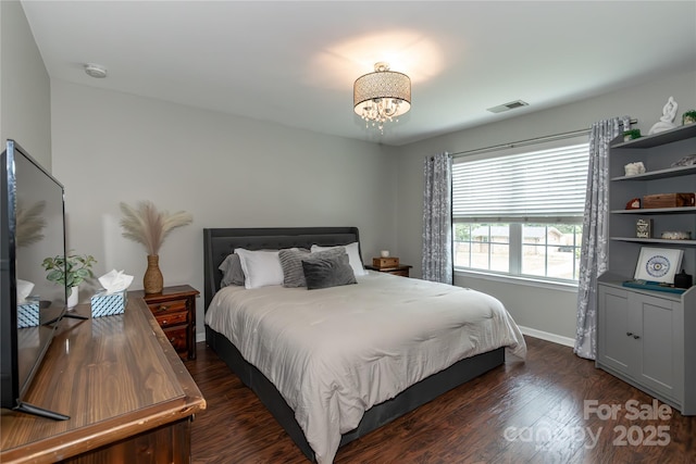4924 Riverdale Dr, Charlotte, NC 28273 - bedroom with baseboards, a notable chandelier, dark wood-type flooring, and visible vents