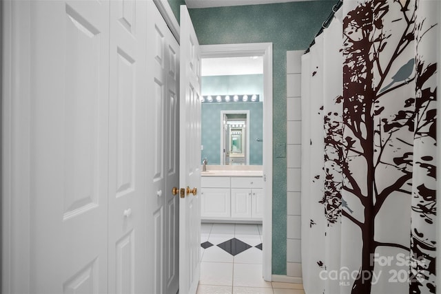 bathroom featuring wallpapered walls, curtained shower, tile patterned flooring, and vanity