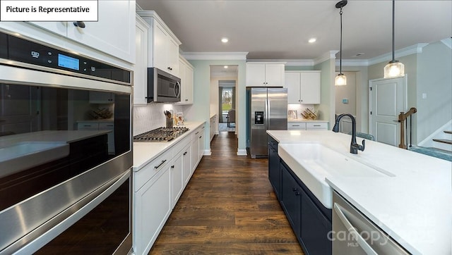 152 Ventor Way, Mooresville, NC 28115 - kitchen with a sink, ornamental molding, pendant lighting, white cabinets, and appliances with stainless steel finishes