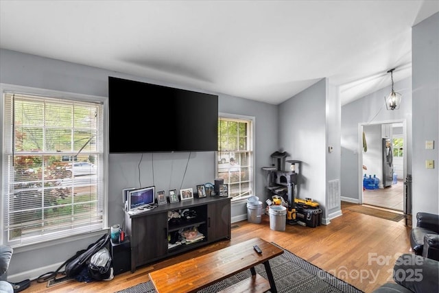 3612 Winterfield Pl, Charlotte, NC 28205 - living room with visible vents, baseboards, vaulted ceiling, and wood finished floors