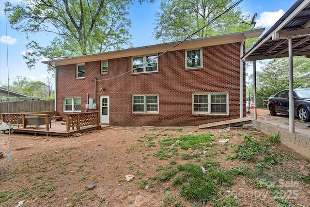 3612 Winterfield Pl, Charlotte, NC 28205 - back of property with brick siding, fence, and a deck