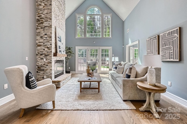 119 Taylor Ct, Mooresville, NC 28117 - living room featuring baseboards, high vaulted ceiling, wood finished floors, and a fireplace