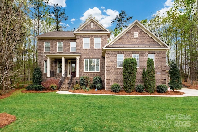 view of front of property with a front yard and brick siding