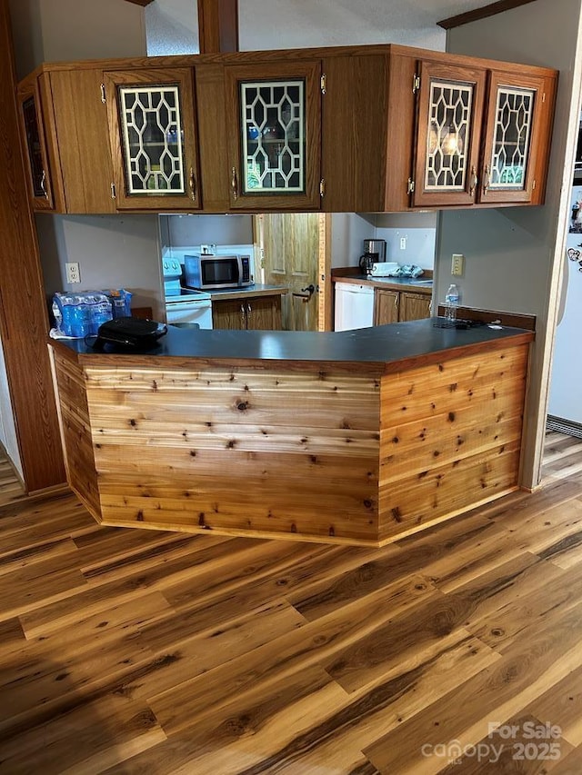 27 Venice Pl, Canton, NC 28716 - kitchen with stainless steel microwave, wood finished floors, dark countertops, and a peninsula