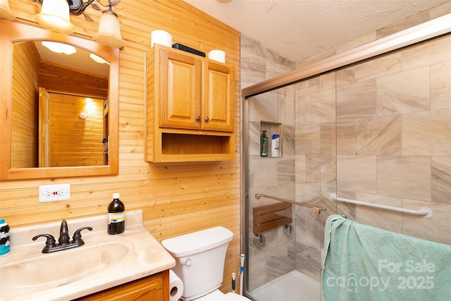 27 Venice Pl, Canton, NC 28716 - bathroom with vanity, a stall shower, wooden walls, and a textured ceiling