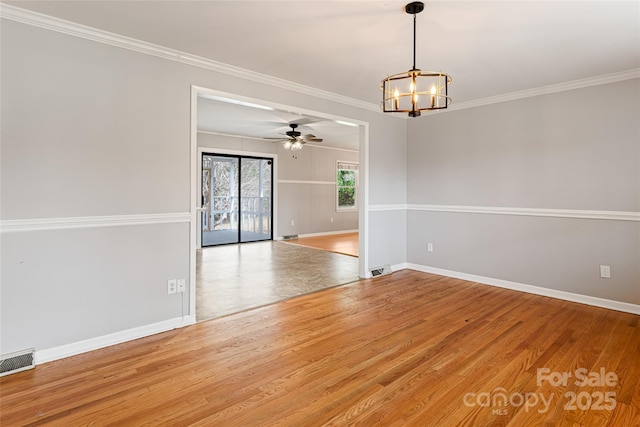 unfurnished room with visible vents, baseboards, ornamental molding, wood finished floors, and ceiling fan with notable chandelier