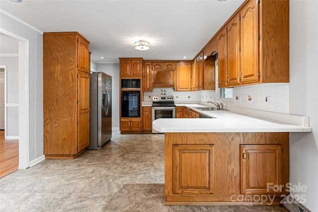 kitchen featuring a peninsula, tasteful backsplash, appliances with stainless steel finishes, and brown cabinets