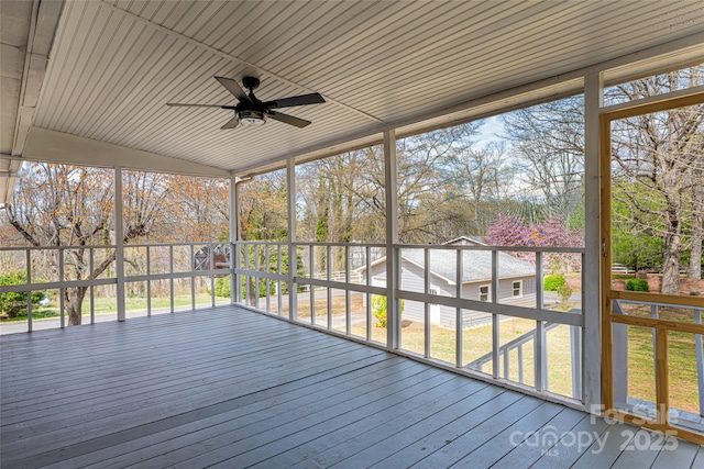 unfurnished sunroom featuring a ceiling fan