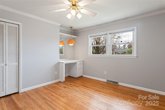 unfurnished bedroom with ornamental molding, light wood-style floors, and visible vents