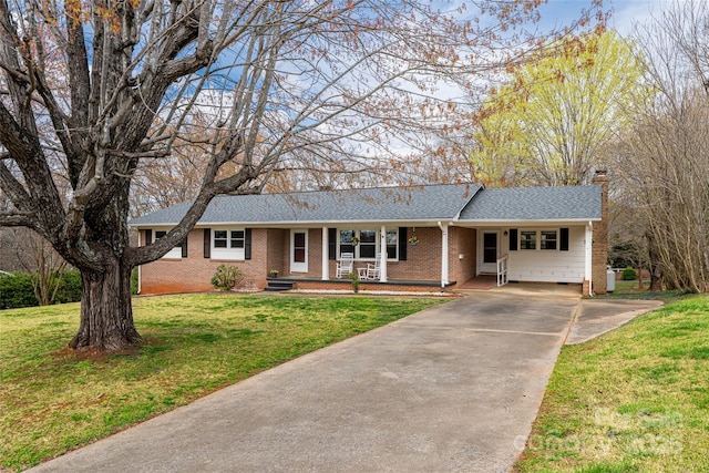 ranch-style house featuring roof with shingles, concrete driveway, an attached carport, brick siding, and a front lawn