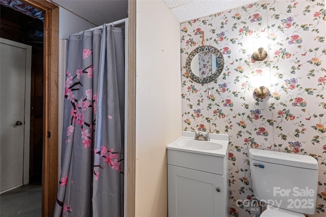 bathroom featuring wallpapered walls, curtained shower, toilet, and vanity