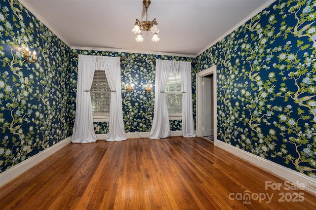 418 3rd St NE, Hickory, NC 28601 - empty room featuring an inviting chandelier, wood finished floors, wallpapered walls, and baseboards