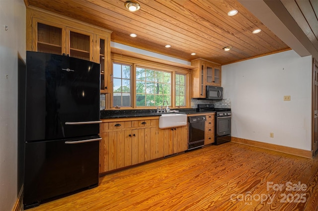 418 3rd St NE, Hickory, NC 28601 - kitchen with light wood-style flooring, dark countertops, baseboards, wooden ceiling, and black appliances