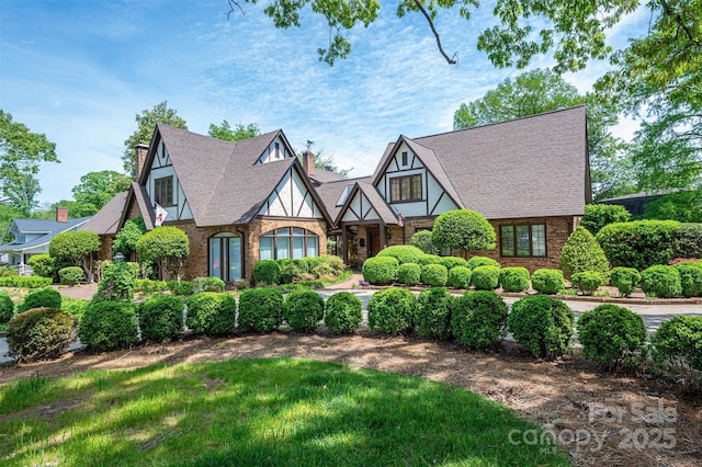 418 3rd St NE, Hickory, NC 28601 - english style home with a chimney, brick siding, and a shingled roof