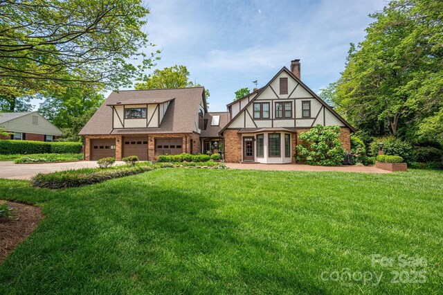 418 3rd St NE, Hickory, NC 28601 - exterior space with a garage, driveway, a chimney, and a front lawn
