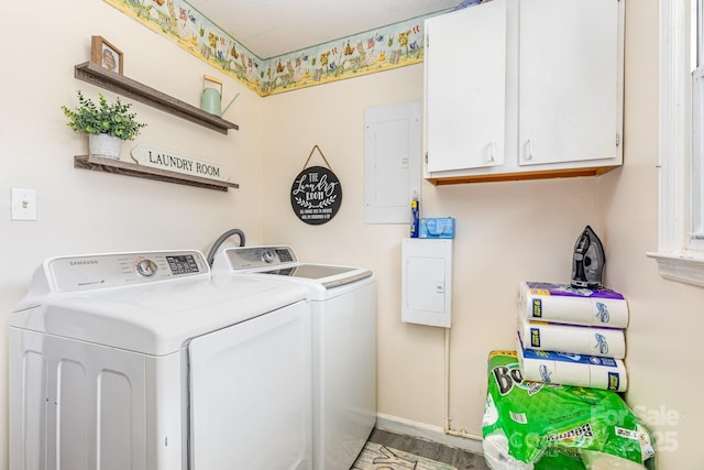 laundry area featuring electric panel, cabinet space, wood finished floors, baseboards, and separate washer and dryer