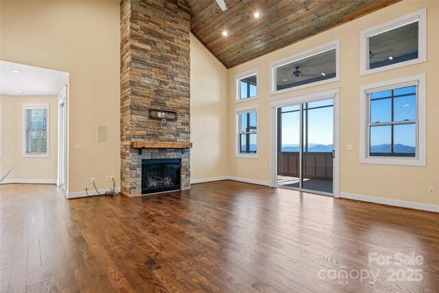 179 Serenity Ridge Trl, Asheville, NC 28804 - unfurnished living room with high vaulted ceiling, hardwood / wood-style flooring, baseboards, a fireplace, and wood ceiling